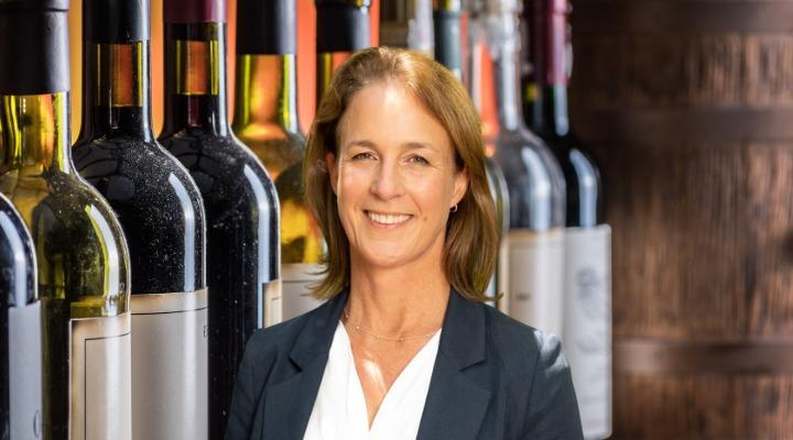 Woman in front of wine bottles