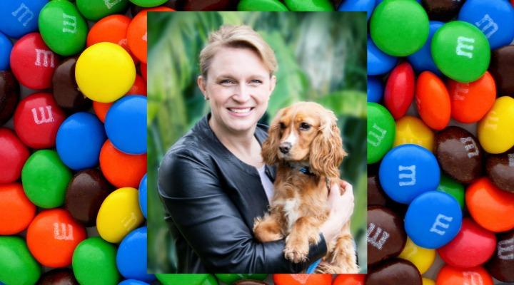 Emily with dog in front of m&m's