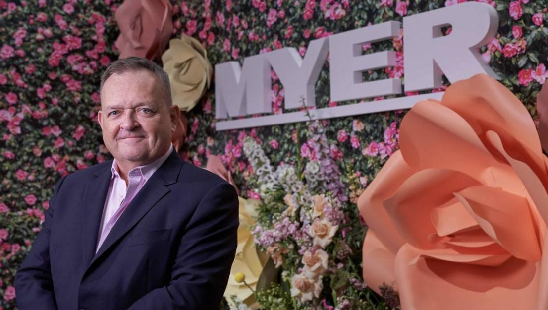 Man in front of Myer sign